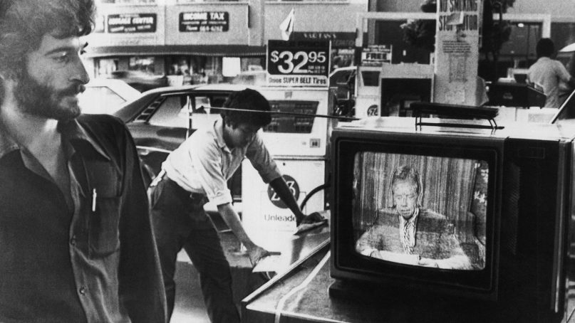 Rami, a gas station manager, watches President Jimmy Carter giving his energy speech over national television, July 15, 1979, in Los Angeles. (AP Photo/Mao)