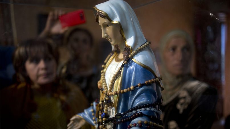 Christian worshippers gathered next to a statue of the Virgin Mary that they said ‘weeps' oil, in, a small town in northern Israel in 2014.  (AP Photo/Ariel Schalit)