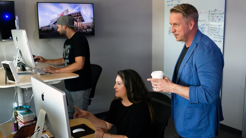 Bobby Gruenewald, right, innovation leader for Life Church, founder of the YouVersion Bible app, works with his team in Edmond, Okla., on June 26, 2018.  Celebrating its 10th anniversary, the app has been downloaded on 330 million devices and in every country in the world, according to the church. Photo courtesy of Life Church