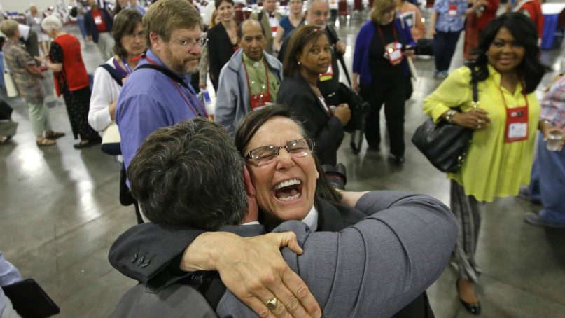 The Rev. Cynthia Black, left, and the Rev. Bonnie Perry, right, hug after Episcopalians overwhelmingly voted July 1, 2015, to allow religious weddings for same-sex couples. The vote came in Salt Lake City at the Episcopal General Convention, just days after the U.S. Supreme Court legalized gay marriage nationwide. (AP Photo/Rick Bowmer)
