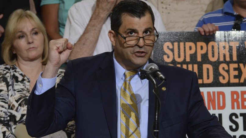 Pennsylvania state Rep. Mark Rozzi speaks at a rally June 12, 2018, in Harrisburg, Pa., to support legislation he has written to lift time limits for authorities to pursue charges of child sexual abuse and for those onetime child victims to sue their attackers and institutions that covered it up. Rozzi plans to renew his push for the bill after the expected publication of a sweeping grand jury report on allegations of child sexual abuse and cover-ups within six Roman Catholic dioceses around Pennsylvania. (AP Photo/Marc Levy)