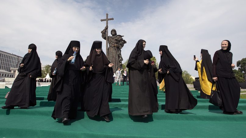 Orthodox nuns walk in front of the monument of Prince Vladimir after a ceremony marking the 1,030th anniversary of the adoption of Christianity by Prince Vladimir, the leader of Kievan Rus, a loose federation of Slavic tribes that preceded the Russian state in Moscow, Russia, on July 28, 2018. Speaking to a crowd of thousands of clergy and believers at the statue near the Kremlin, President Putin said adopting Christianity was 