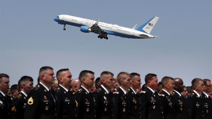 A Boeing C-32 military aircraft carrying the casket of Sen. John McCain takes off as members from the Arizona Army and Air National Guard stand on the tarmac to pay respects on Aug. 30, 2018, in Phoenix. McCain will lie in state at the U.S. Capitol on Friday before a memorial service at the National Cathedral on Saturday and then being buried at the U.S. Naval Academy Cemetery in Annapolis, Md., on Sunday. (AP Photo/Jae C. Hong)