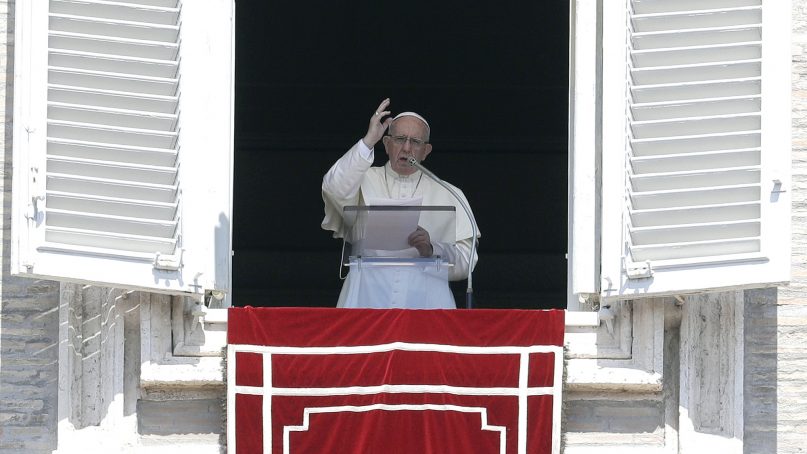 Pope Francis delivers a blessing during the Angelus noon prayer in St. Peter's Square, at the Vatican, on Aug. 19, 2018. (AP Photo/Gregorio Borgia)