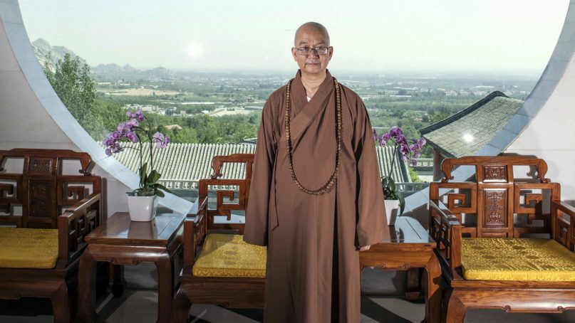In this July 3, 2015, file photo, Abbot Xuecheng of the Beijing Longquan Temple poses for a photo in one of the temple buildings in Beijing, China. According to a statement issued Thursday, Aug. 23, 2018, Chinese police have opened an investigation into sexual misconduct allegations against one of the country's best-known Buddhist monks whose case has highlighted the growth of the #MeToo movement in China. (Chinatopix via AP, File)