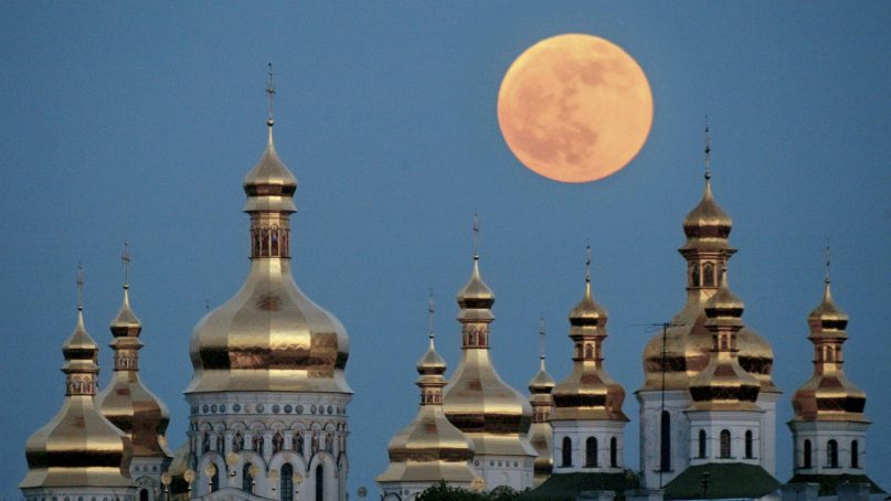 In this May 4, 2004, file photo, a full moon rises above the golden domes of the Orthodox Monastery of the Caves in Kiev, Ukraine. Ukraine is lobbying hard for a religious divorce from Russia and some observers say the issue could be decided as soon as September 2018. (AP Photo/Efrem Lukatsky, File)