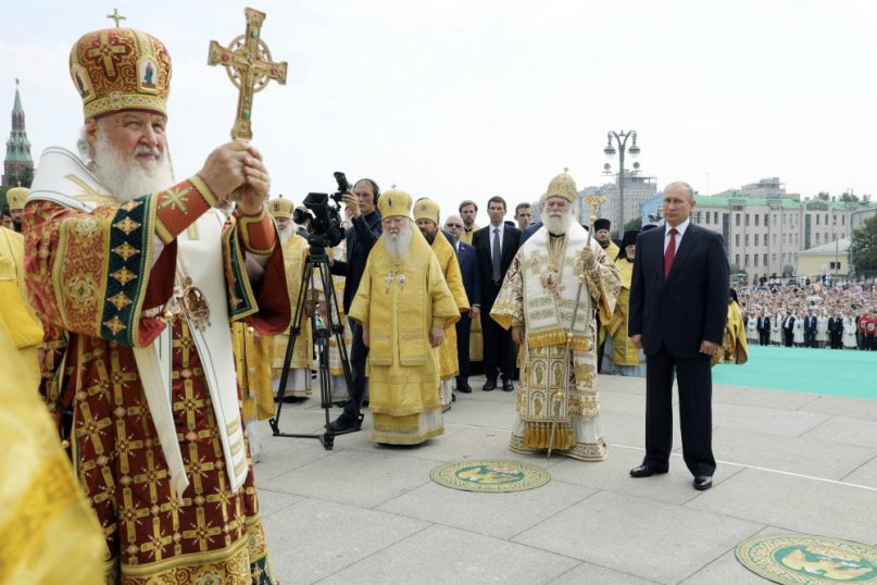 In this file photo taken on Saturday, July  28, 2018, Russian Orthodox Church Patriarch Kirill, left, leads a religion service as Russian President Vladimir Putin, right, and Eastern Orthodox Patriarch of Alexandria and all Africa Theodoros II, second right, attends a ceremony marking the 1,030th anniversary of the adoption of Christianity by Prince Vladimir, the leader of Kievan Rus, a loose federation of Slavic tribes that preceded the Russian state in Moscow, Russia. The Russian hackers unmasked by the U.S. special prosecutor last month have spent years trying to steal the private correspondence of the world’s most senior Christian Orthodox figures, The Associated Press has found, an illustration of how high the stakes are as Kiev and Moscow wrestle over the religious future of Ukraine. (Mikhail Klimentyev, Sputnik, Kremlin Pool Photo via AP, File)