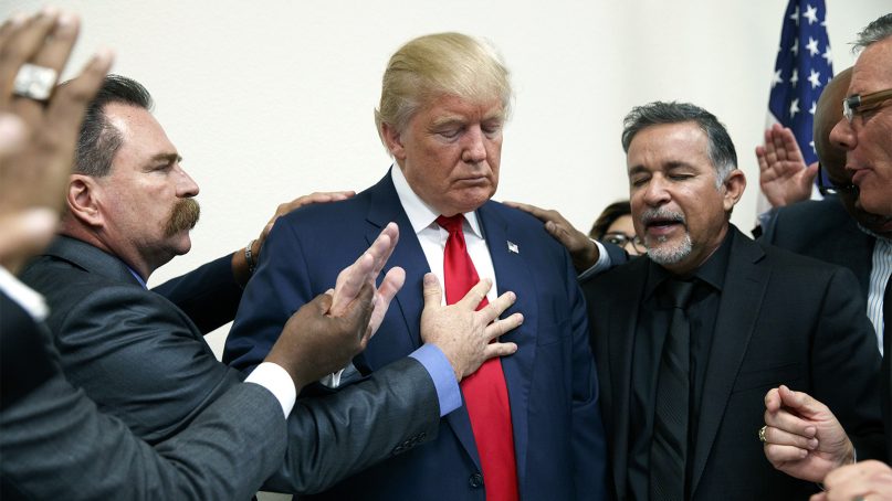 Pastors from the Las Vegas area pray with then-Republican presidential candidate Donald Trump during a visit to the International Church of Las Vegas, and International Christian Academy, on Oct. 5, 2016, in Las Vegas. (AP Photo/ Evan Vucci)
