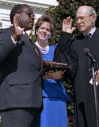 Clarence Thomas being sworn in by Byron White, as wife Virginia Lamp Thomas looks on.