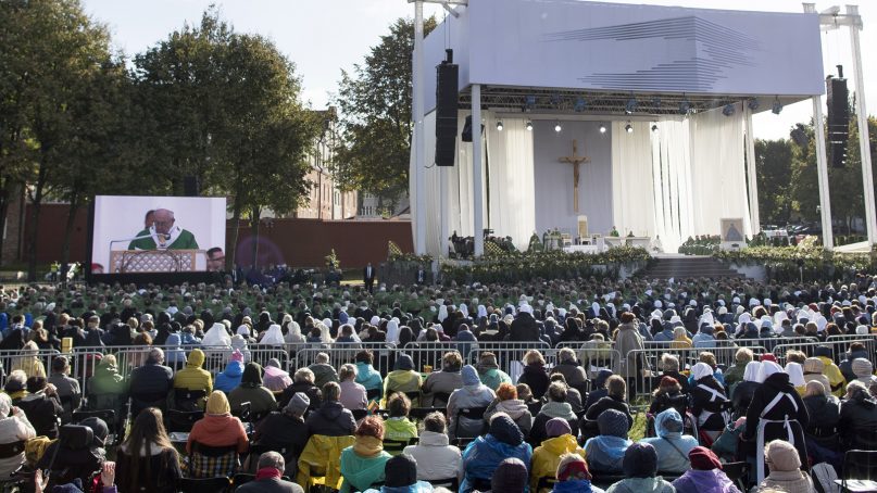 Pope Francis is seen on a giant screen at left, as he celebrates an open-air Mass at Santakos Park, in Kaunas, Lithuania, on Sept. 23, 2018. Francis is paying tribute to Lithuanians who suffered and died during Soviet and Nazi occupations on the day the country remembers the near-extermination of its centuries-old Jewish community during the Holocaust. (AP Photo/Mindaugas Kulbis)