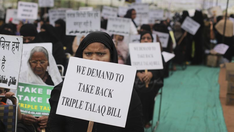 Muslim women participate in a protest against the draft law for banning 