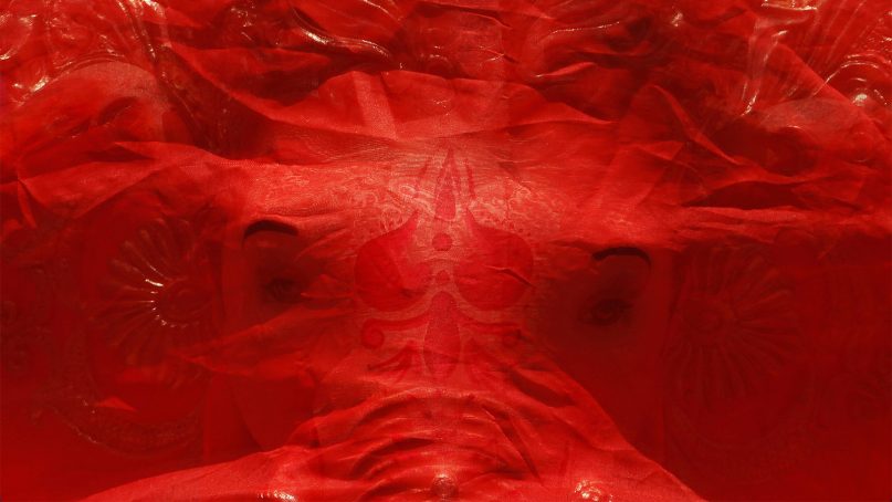An idol of elephant-headed Hindu god Ganesha is wrapped in a red cloth as it is transported on a vehicle for Ganesha Chaturthi festival in Ahmadabad, India, on Sept. 13, 2018. The ten-day long festival celebrating the birth of Ganesha began Sept. 13. (AP Photo/Ajit Solanki)