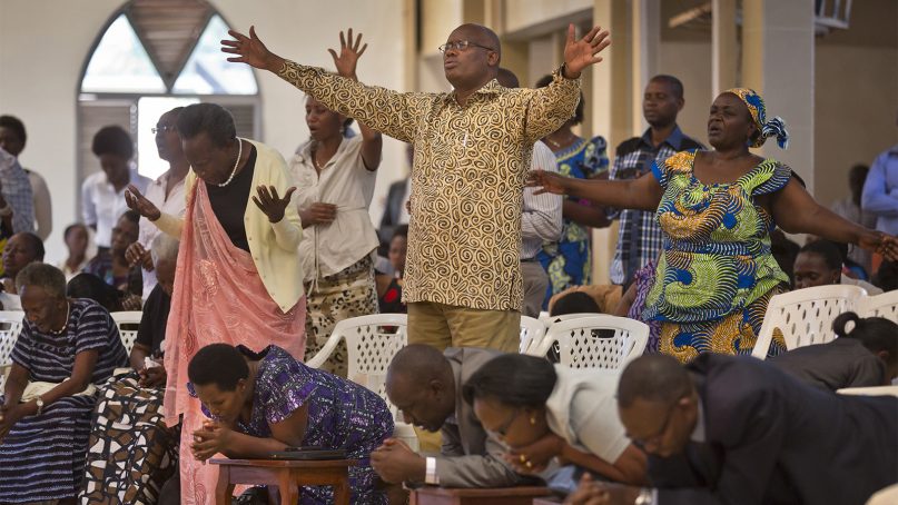 Rwandans sing and pray at the Evangelical Restoration Church in the Kimisagara neighborhood of the capital, Kigali, Rwanda, on April 6, 2014. Rwanda's government has closed numerous churches and mosques in 2018 as it seeks to assert more control over a vibrant religious community whose sometimes makeshift operations, authorities say, have threatened the lives of followers. (AP Photo/Ben Curtis)