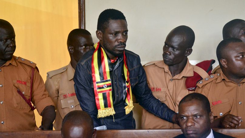 Ugandan pop star-turned-lawmaker Robert Kyagulanyi Ssentamu, also known as Bobi Wine, center, arrives at a magistrate's court in Gulu, northern Uganda, on Aug. 23, 2018. Wine, who opposes longtime President Yoweri Museveni, was charged with treason in the civilian court in Gulu, minutes after a military court dropped weapons charges. (AP Photo)