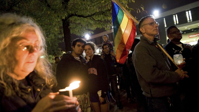 People participate in a candlelight vigil for Rutgers University freshman Tyler Clementi at Brower Commons on the Rutgers campus in New Brunswick, N.J., on Oct. 3, 2010. Clementi killed himself on Sept. 22, 2010, after being bullied for being gay. (AP Photo/Reena Rose Sibayan, File)