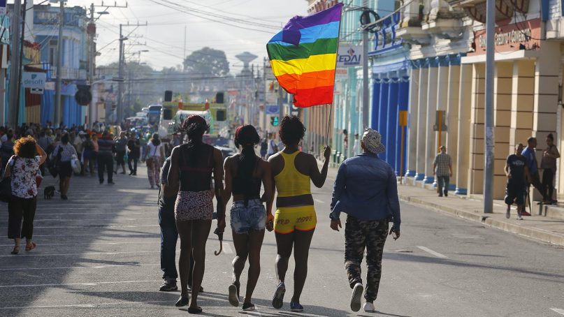 Members of the LGBT community walk down the main street to take part in a parade marking the International Day Against Homophobia, Transphobia and Biphobia, in Pinar Del Rio, Cuba, on May 17, 2018. (AP Photo/Desmond Boylan)
