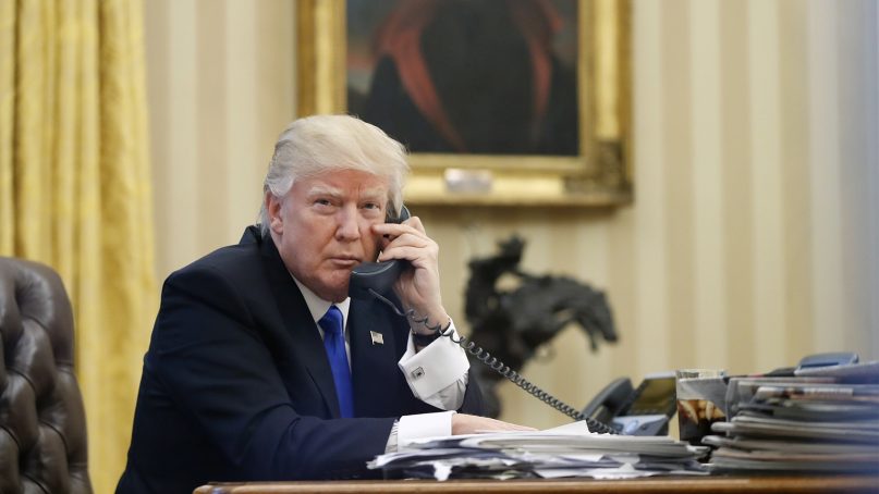 President Trump speaks on the phone in the Oval Office of the White House. (AP Photo/Alex Brandon)