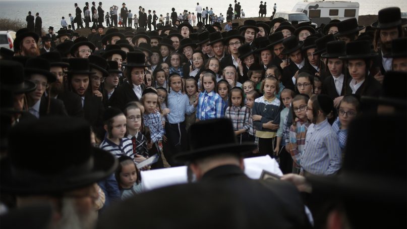 Ultra-Orthodox Jewish males of the Vizhnitz Hassidic sect listen to their rabbi on a hill overlooking the Mediterranean Sea as they participate in a Tashlich ceremony in Herzliya, Israel, on Sept. 17, 2018. Tashlich, which means 