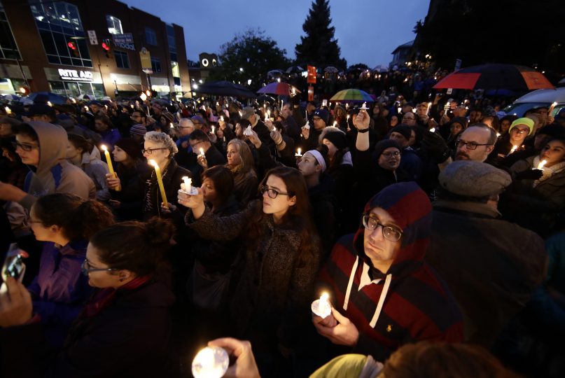People hold candles as they gather for a vigil in the aftermath of a deadly shooting at the Tree of Life Congregation, in the Squirrel Hill neighborhood of Pittsburgh, on Oct. 27, 2018. (AP Photo/Matt Rourke)