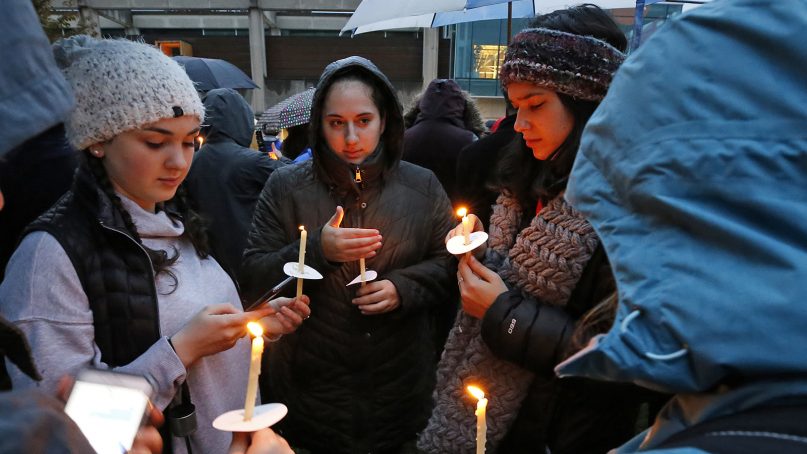 Holding candles, a group of girls waits for the start of a memorial vigil at the intersection of Murray Avenue and Forbes Avenue in the Squirrel Hill section of Pittsburgh for the victims of the shooting at the Tree of Life Synagogue. A shooter opened fire Oct. 27, 2018, killing multiple people and wounding others, including several police officers. (AP Photo/Gene J. Puskar)