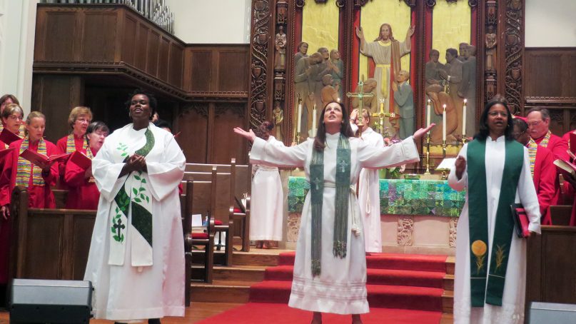 The Rev. Ginger Gaines-Cirelli, center, gives the benediction at Foundry United Methodist Church in Washington, D.C., on July 27, 2014. The Rev. Theresa S. Thames, associate pastor, left, and the Rev. Dawn M. Hand, executive pastor, right, joined her. RNS photo by Adelle M. Banks