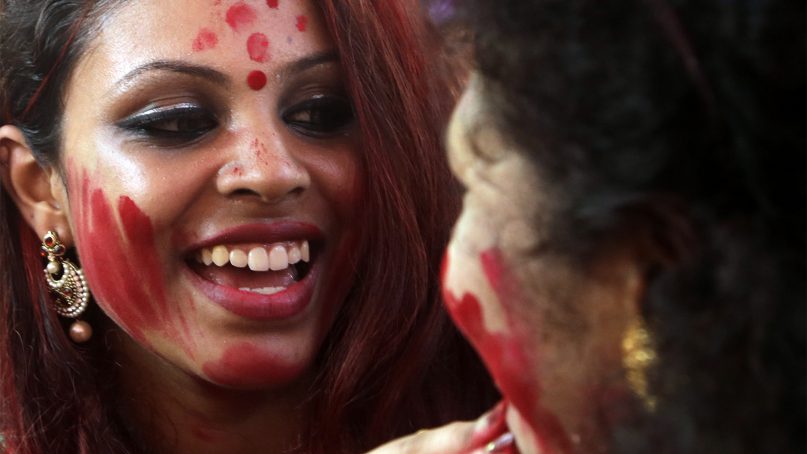 Indian women smear vermilion powder on each other during Vijayadashmi celebrations in Mumbai, India, on Oct. 19, 2018. Vijayadashami, also known as Dussehra, commemorates the victory of the Hindu god Rama over demon god Ravana. The festivity is marked with the burning of effigies of Ravana, signifying the victory of good over evil. (AP Photo/Rajanish Kakade)