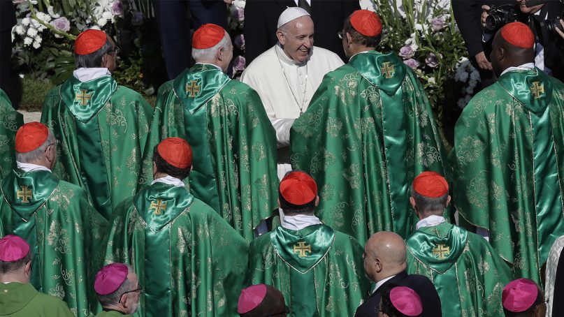 Pope Francis, top, greets cardinals at the end of the opening Mass for the Synod of Bishops on Young People, in St. Peter's Square at the Vatican, on Oct. 3, 2018. (AP Photo/Alessandra Tarantino)