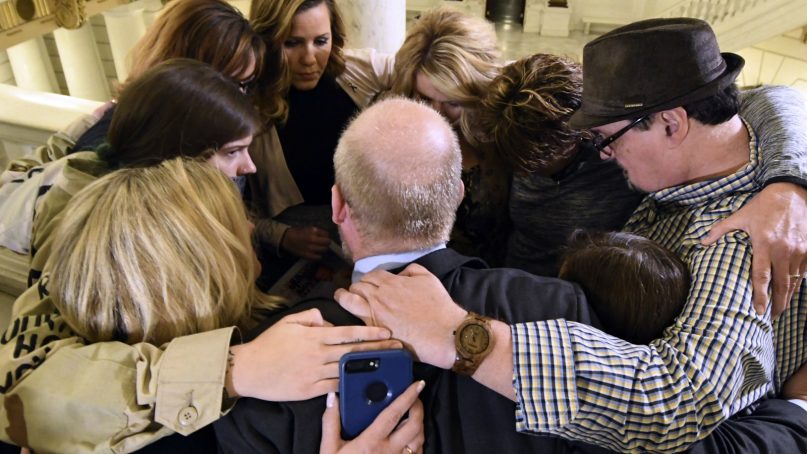 Survivors of child sexual abuse hug in the Pennsylvania Capitol while awaiting legislation to respond to a landmark state grand jury report on child sexual abuse in the Roman Catholic Church, Wednesday, Oct. 17, 2018 in Harrisburg, Pa. (AP Photo/Marc Levy)