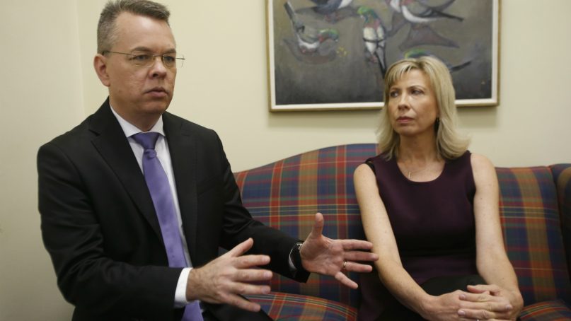 Pastor Andrew Brunson, left, gestures as his wife, Norine, listens during an interview at the headquarters of Christian Broadcasting Network in Virginia Beach, Va., on Oct. 19, 2018. Andrew Brunson was recently released from prison in Turkey. (AP Photo/Steve Helber)
