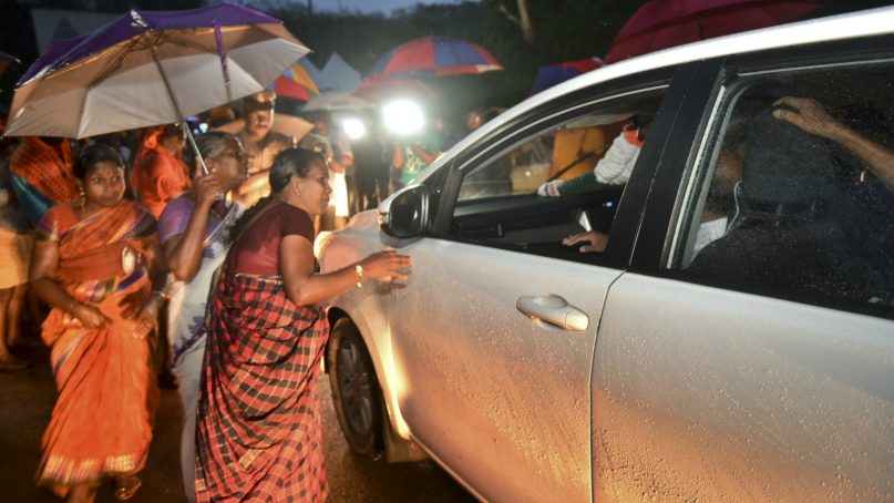 Hindu women who favor barring women of menstruating age from entering the Sabarimala temple scan vehicles at Nilackal, a base camp on the way to the mountain shrine in Kerala, India, on Oct. 16, 2018. The historic mountain shrine reopens Wednesday for the first time after India's Supreme Court lifted the ban, holding that equality is supreme irrespective of age and gender. Devotees have been protesting against the verdict, demanding that the customs and rituals of the temple should be protected. (AP Photo)
