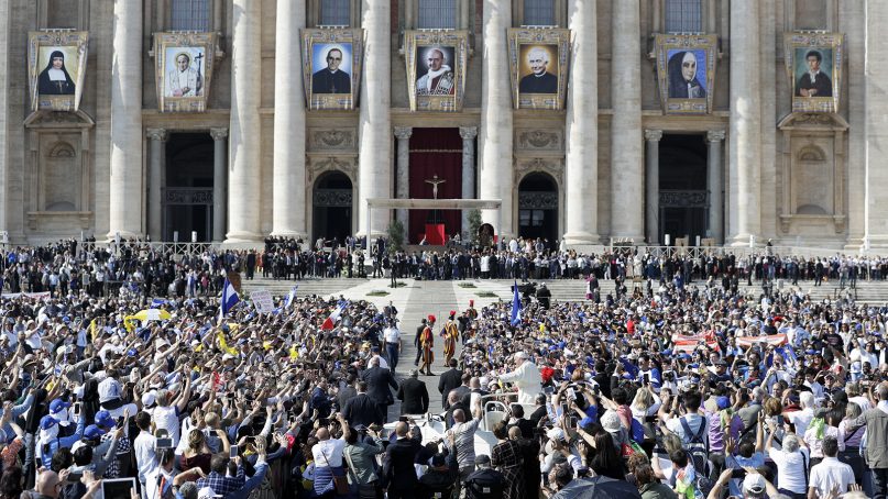 Pope Francis, lower center, leaves at the end of a canonization ceremony in St. Peter's Square at the Vatican on Oct. 14, 2018. Pope Francis has praised two of the towering figures of the 20th-century Catholic Church as prophets who shunned wealth and looked out for the poor as he canonized the modernizing Pope Paul VI and martyred Salvadoran Archbishop Oscar Romero. Francis declared the two men saints at a Mass in St. Peter's Square before tens of thousands of pilgrims, a handful of presidents and some 5,000 Salvadoran pilgrims who traveled to Rome. (AP Photo/Andrew Medichini)