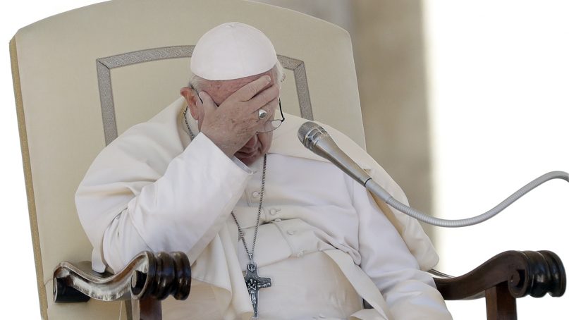 Pope Francis touches his forehead during his weekly general audience in St. Peter's Square at the Vatican, on Sept. 26, 2018. (AP Photo/Andrew Medichini)