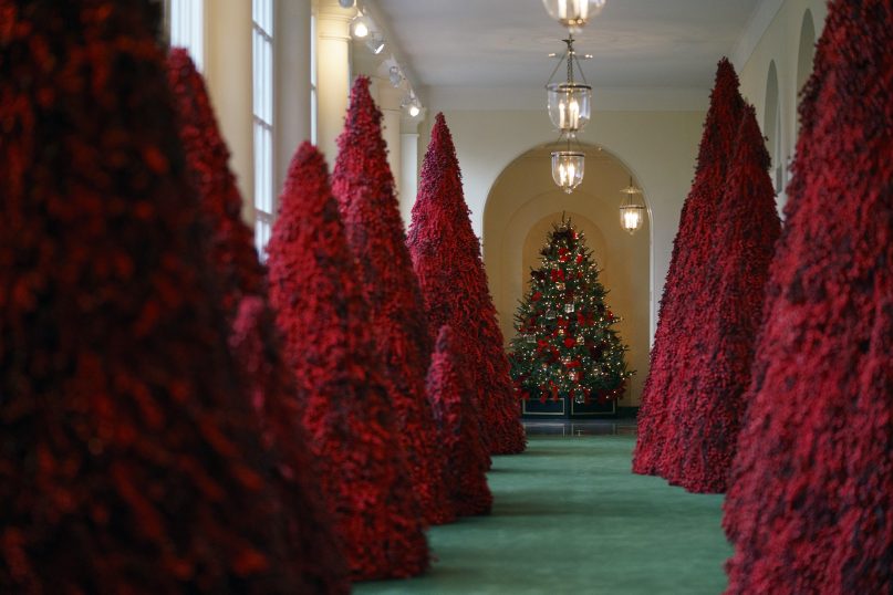 Topiary trees line the East colonnade at the White House in Washington on Nov. 26, 2018. Christmas has arrived at the White House. First lady Melania Trump unveiled the 2018 White House holiday decor on Monday. She designed the decor, which features a theme of 