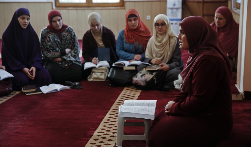 Agime Sogojeva, second from right, a professor of Islamic studies, holds a class inside the Haxhi Veseli mosque in the northern Kosovo town of Mitrovica on Nov. 12, 2018. (AP Photo/Visar Kryeziu)