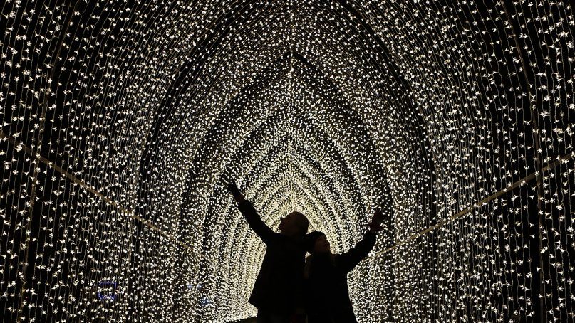 Children walk through the Cathedral of Light as part of the illuminated trail through Kew Gardens magnificent after-dark landscape, lit up by over one million twinkling lights in London, on Nov. 21, 2018. The spectacular light and sound installations run from Nov. 22, 2018 – Jan. 5, 2019.(AP Photo/Frank Augstein)