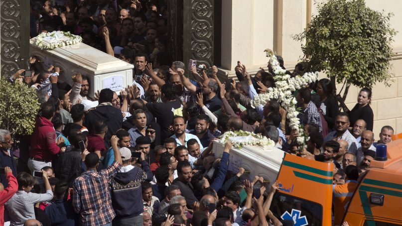 Relatives and friends carry the coffins of brothers Nadi Yousef Shehata, right, and Reda Yousef Shehata after a funeral service at the Church of Great Martyr Prince Tadros, in Minya, Egypt, on Nov. 3, 2018. Coptic Christians in the Egyptian town of Minya prepared to bury their dead a day after militants ambushed three buses carrying Christian pilgrims on their way to a remote desert monastery. (AP Photo/Amr Nabil)