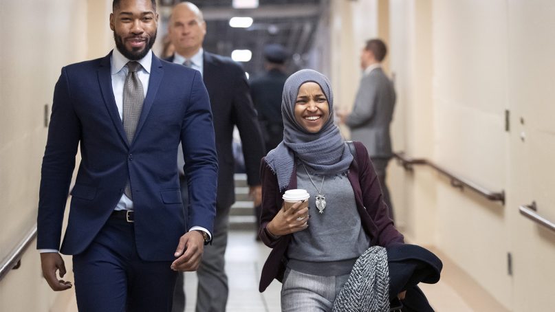 Rep.-elect Ilhan Omar, D-Minn., right, heads to a Democratic Caucus meeting Nov. 15, 2018, in the basement of the Capitol in Washington as new members of the House and veteran representatives met to discuss their agenda when they become the majority in the 116th Congress. (AP Photo/J. Scott Applewhite)