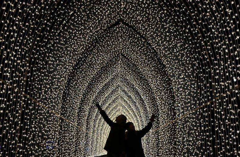Children walk through the Cathedral of Light as part of the illuminated trail through Kew Gardens magnificent after-dark landscape, lit up by over one million twinkling lights in London, on Nov. 21, 2018. (AP Photo/Frank Augstein)