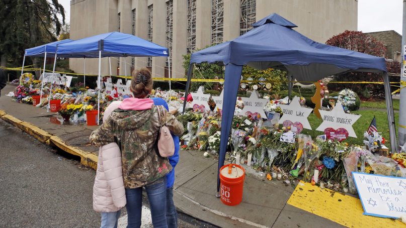 A woman and her children pause Nov. 3, 2018, to take in a makeshift memorial outside the Tree of Life synagogue honoring the 11 people killed Oct 27, 2018, while worshipping in the Squirrel Hill neighborhood of Pittsburgh. (AP Photo/Gene J. Puskar)