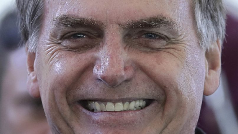 Brazil's president-elect, Jair Bolsonaro, smiles during a lunch with popular singers who supported his campaign, at the Army Club in Brasilia, Brazil, on Dec. 11, 2018. Bolsonaro will be sworn in as Brazil's next president on Jan. 1. (AP Photo/Eraldo Peres)
