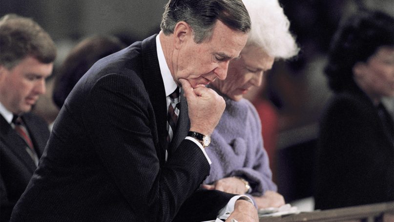President George H.W. Bush and his wife, Barbara, kneel and pray during the National Prayer Service Jan. 22, 1989, at Washington National Cathedral. (AP Photo/Doug Mills)
