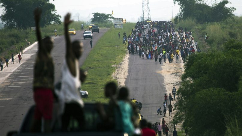 Thousands of supporters of opposition candidate Martin Fayulu make their way toward Nsele, 30 miles east of Kinshasa, Congo, on Dec. 19, 2018. Days before Congo's elections, Kinshasa's governor banned campaign rallies in the capital city, citing security concerns. The ban angered supporters of  Fayulu who had gathered for a rally in Kinshasa. Hundreds of Fayulu's supporters gathered on the outskirts of Kinshasa hoping to see their candidate but Congo's police dispersed them by firing tear gas. (AP Photo/Jerome Delay)