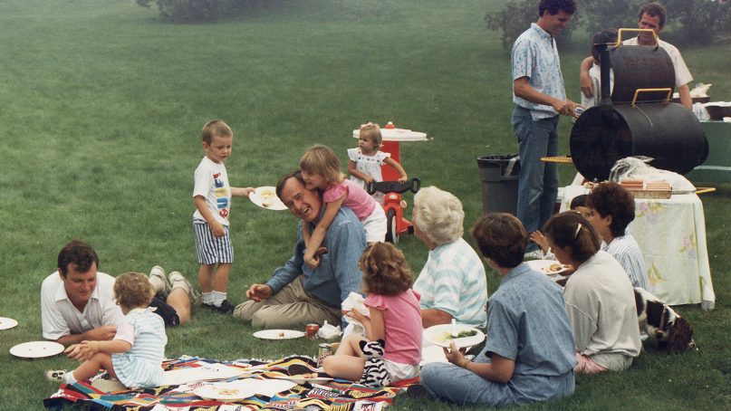 George H.W. Bush, center, picnics on the lawn of his home in Kennebunkport, Maine, with his family in 1988.  Photo courtesy of Creative Commons/David Valdez