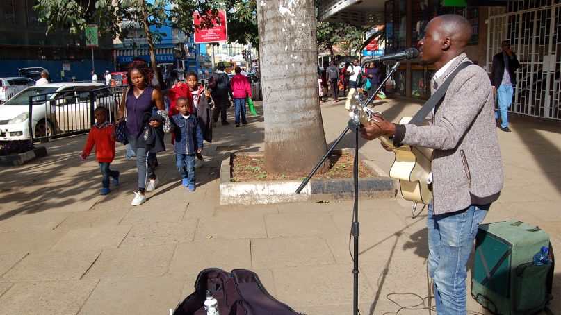 Samson Kule Mannasseih plays Christmas music on a sidewalk in Nairobi, Kenya, on Dec. 8, 2018. RNS photo by Fredrick Nzwili