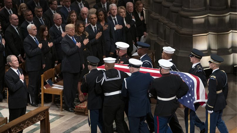 The flag-draped casket of former President George H.W. Bush is carried by a military honor guard past former President George W. Bush, President Donald Trump, first lady Melania Trump, former President Barack Obama, Michelle Obama, former President Bill Clinton, former Secretary of State Hillary Clinton, former President Jimmy Carter, and Rosalynn Carter at the end of a state funeral at Washington National Cathedral on Dec. 5, 2018, in Washington. (AP Photo/Carolyn Kaster)