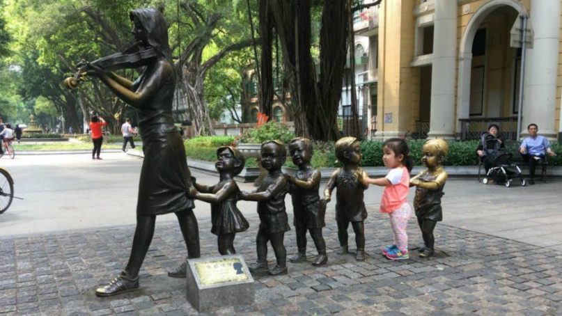 Teagan (Tian Xin Yue) plays at a sculpture on Shamian Island in Guangzhou, China, while her parents were finalizing some of the last adoption paperwork earlier this year. Photo courtesy of the Worley family