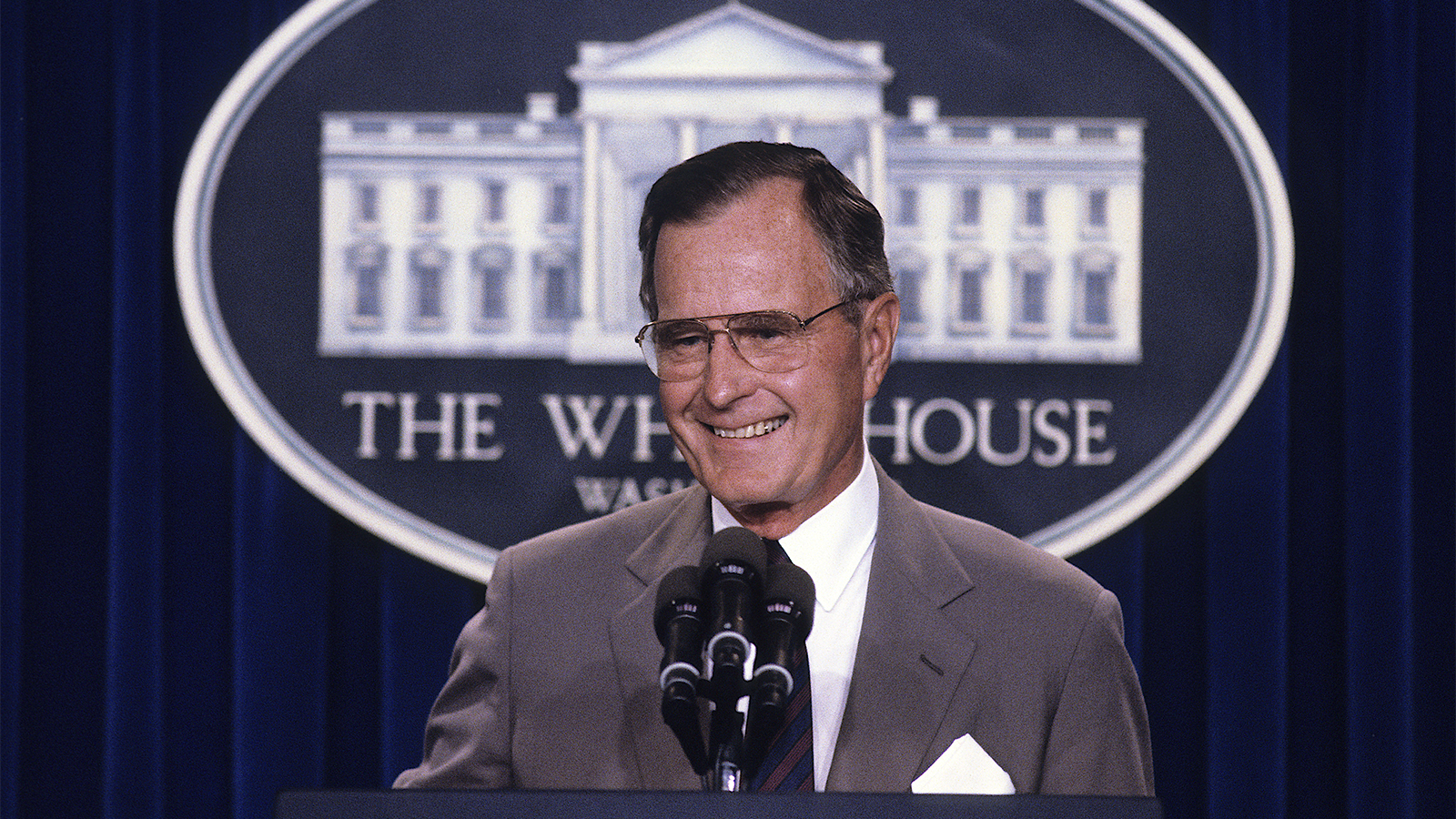President George H.W. Bush responds to questions during a news conference at the White House in 1990. Photo by Mark Reinstein/MediaPunch /IPX