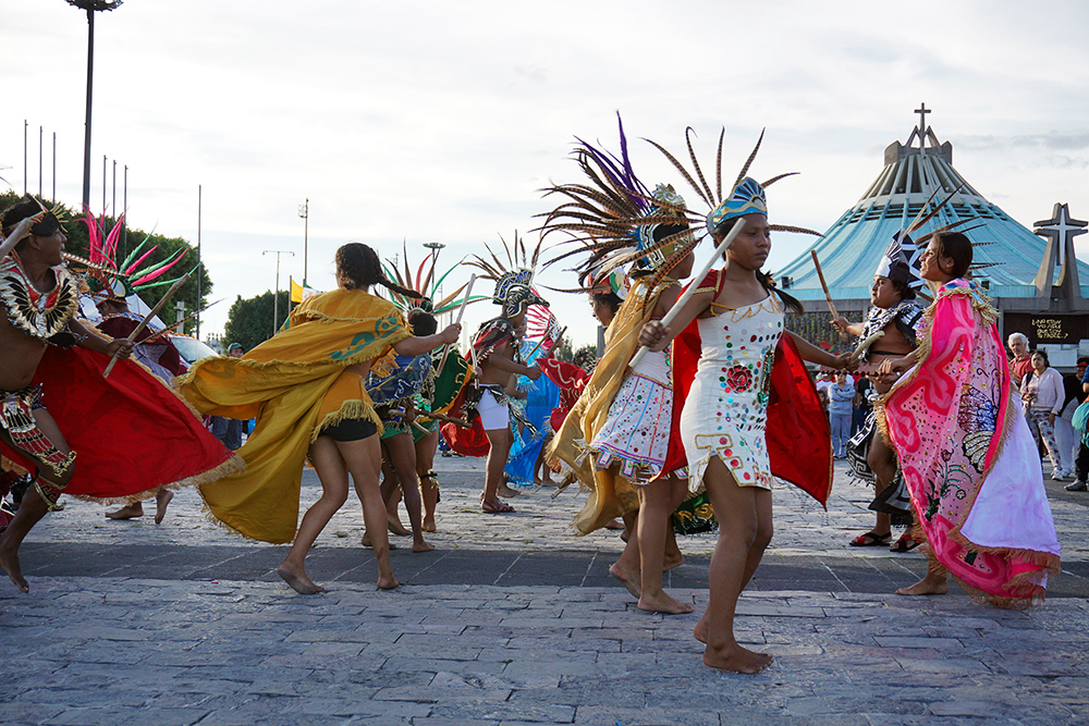 Dancers wear indigenous attire while performing in honor of the Virgin of Guadalupe in the plaza of the Basilica of Our Lady of Guadalupe in northern Mexico City. The Our Lady of Guadalupe feast day is Dec. 12. RNS photo by Irving Cabrera Torres