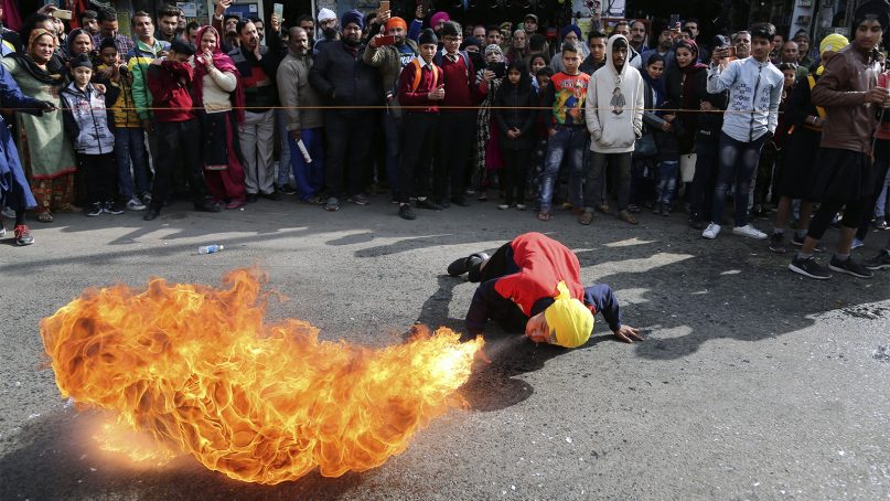 An Indian Sikh warrior blows fire as he displays traditional martial art skills during a religious procession ahead of the birth anniversary of Guru Gobind Singh in Jammu, India, on Jan. 3, 2019. The birth anniversary of Guru Gobind Singh, the tenth Sikh guru, is marked on Jan. 5. (AP Photo/Channi Anand)