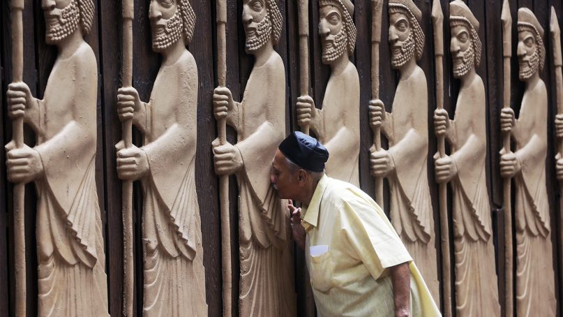 A Parsi man offers prayers at a bas-relief of ancient priests at a fire temple on Navroze, the Parsi New Year, in Mumbai, India, on Aug. 17, 2018. Parsis, also known as Zoroastrians, are followers of the Bronze Age Persian prophet Zarathustra. (AP Photo/Rajanish Kakade)
